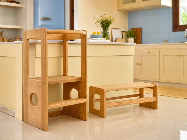 Rounded light solid-wood learning tower and low step in a warm kitchen